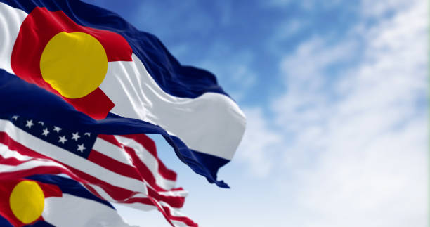 istock Colorado and US flags waving in the wind on a clear day 2172703822