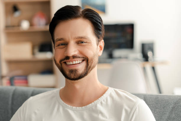 istock Happy businessman smiling while sitting on couch at home office 2172706024