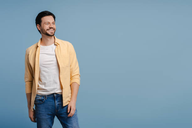 istock Handsome young man smiling and looking away on copy space on blue background 2172707463