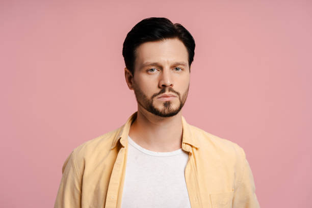 istock Serious bearded man looking at camera concerned isolated on pink background 2172707540