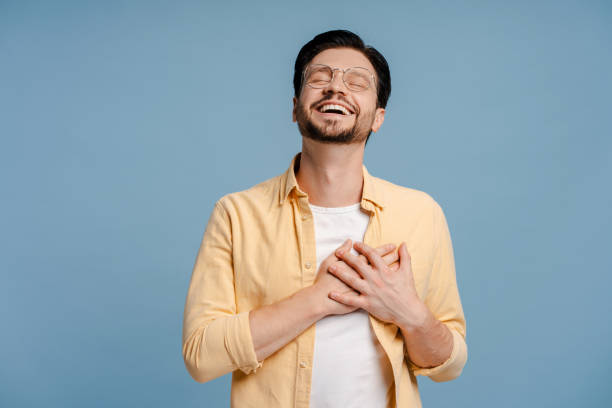 istock Man feeling deep gratitude with hands on chest and eyes closed 2172707553