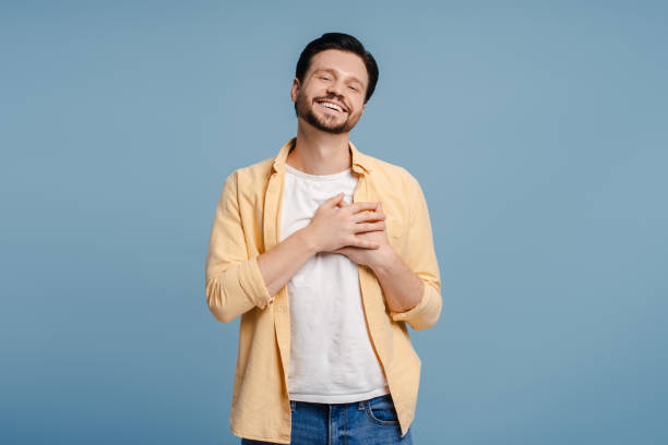 istock Happy, smiling man holding hands on chest expressing sincere gratitude looking at camera 2172707592