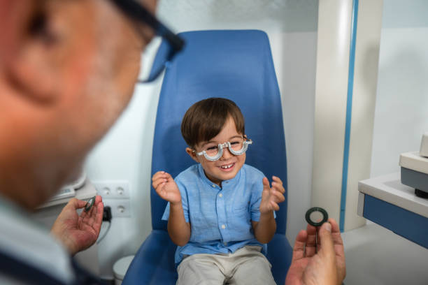 istock Happy boy having fun during eyesight examination wearing trial frame 2172714850