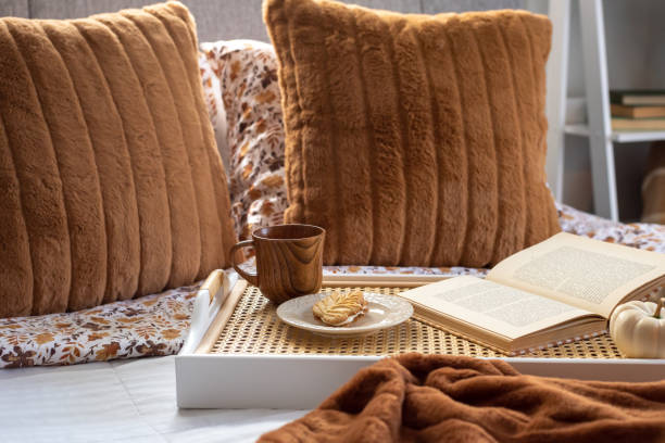 istock Tray with a book and coffee cup on a cozy bed 2172716945