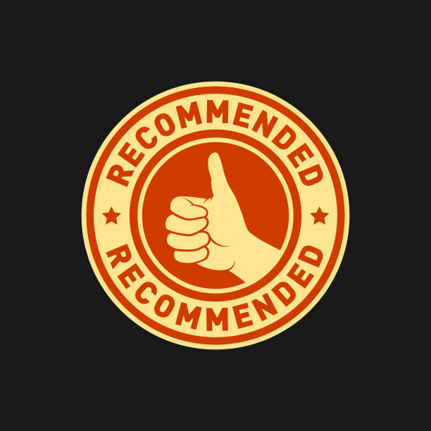 Recommended stamp, badge, sticker, approval seal with the text RECOMMENDED and a hand with a thumbs up sign - round vector icon in light yellow and orange on dark background