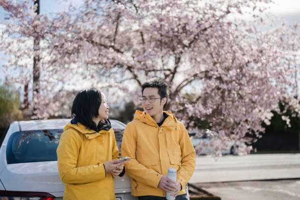 Young couple enjoying a spring chat under cherry blossoms