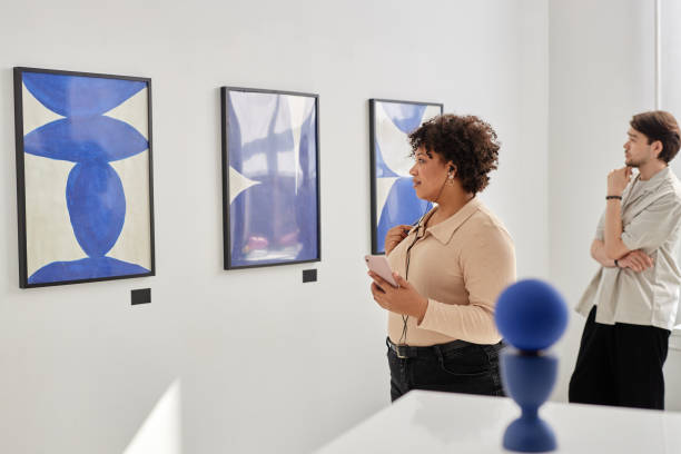 istock People Visiting Art Gallery Looking at Paintings 2172726854