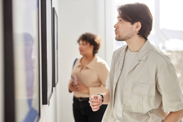 istock Man Looking at Paintings Visiting Art Gallery 2172726880