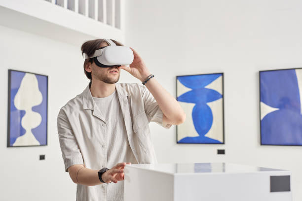 istock Man Wearing VR during Immersive Modern Art Exhibition 2172727079