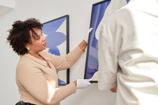 istock Art Gallery Worker Hanging Pictures 2172727184