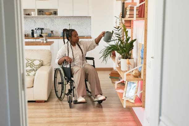 istock Watering Plants in Modern Accessible Apartment 2172728428