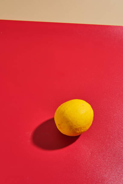 istock Yellow lemons on red background 2172731312