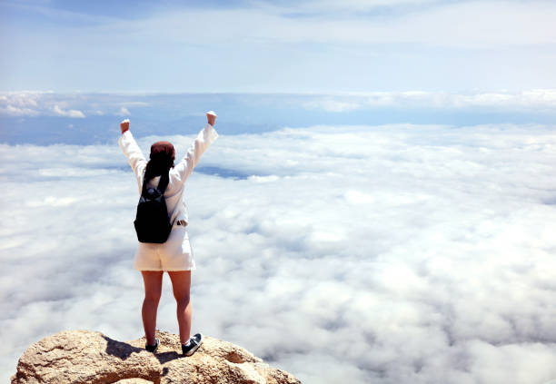 Woman on the mountain top, oncept of freedom, victory, active lifestyle