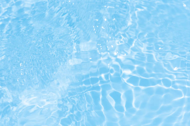 istock Blue water with ripples on the surface. Defocus blurred transparent blue colored clear calm water surface texture with splashes and bubbles. Water waves with shining pattern texture background. 2172736528