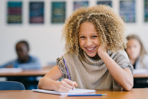 Young student writes in notebook during a school day