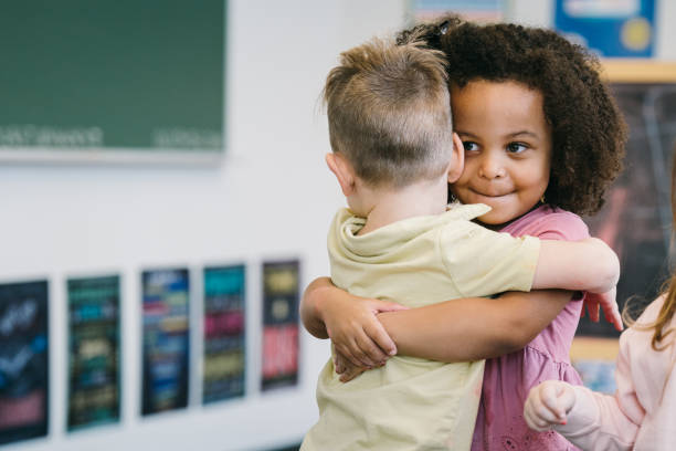 istock Two toddlers embrace in hug during preschool class 2172736745