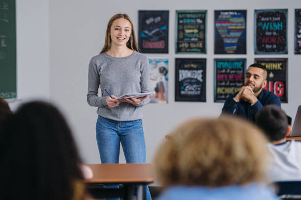 istock Confident tween schoolgirl presents information to her class 2172736886