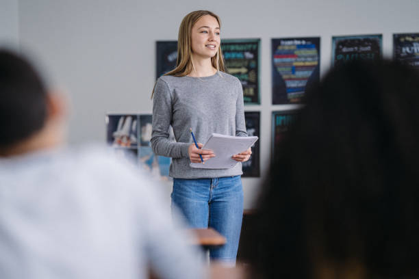 Confident tween schoolgirl presents information to her class