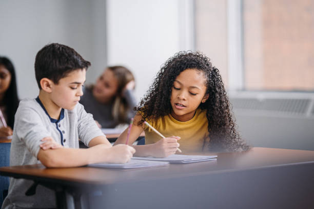 istock Boy and girl work together in class to solve schoolwork 2172736974