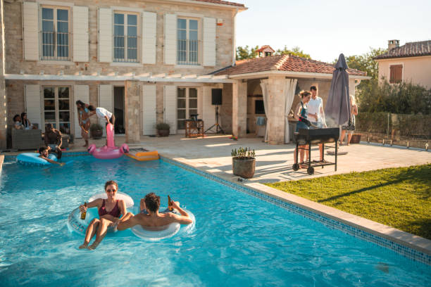 istock Couple on Floaties Taking Selfie at Luxury Villa Pool Party 2172740072