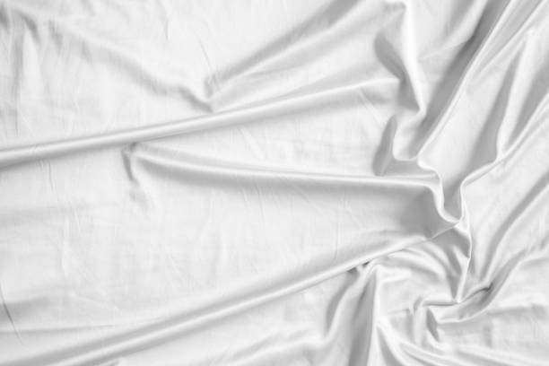 istock Abstract white wrinkled bedding sheet fabric texture background 2172740795