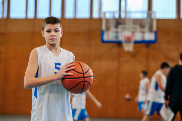 istock Child holding basketball with determination 2172744329