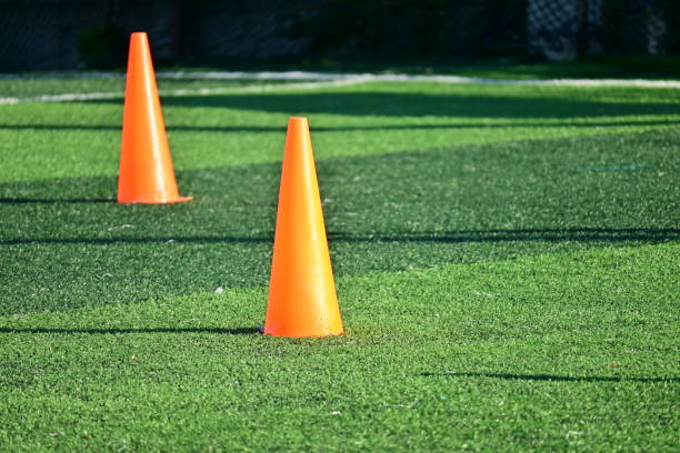 istock artificial green grass soccer field with orange training cones 2172745842