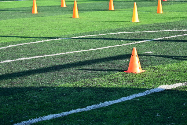 istock artificial green grass soccer field with orange training cones 2172747182