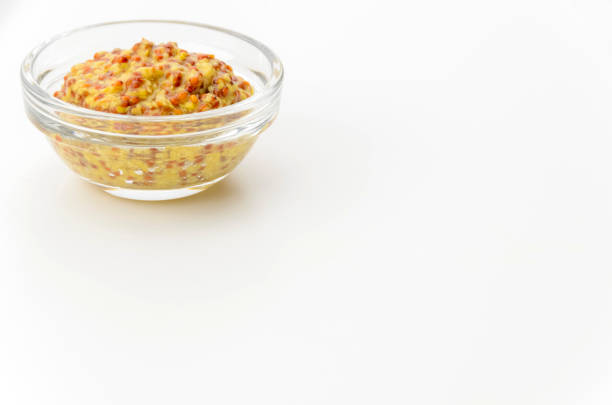 istock whole grain mustard in small glass bowl on white background 2172751479