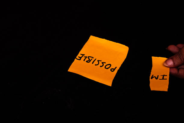 Woman Changing Impossible to I'm Possible on Yellow Note for Motivation Concept