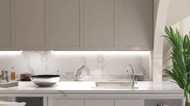 istock White marble kitchen island in modern, luxury kitchen with beige built in cabinet, cupboard in sunlight from window for interior design decoration, product background 3D 2172756533