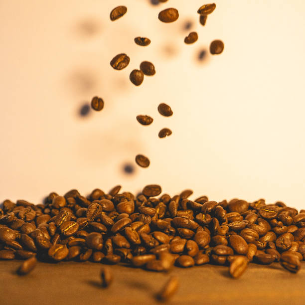 Roasted coffee beans flying in the air. Background for coffee.
