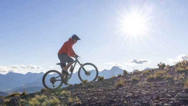 istock Mountain biker rides up mountain ridge 2172762368