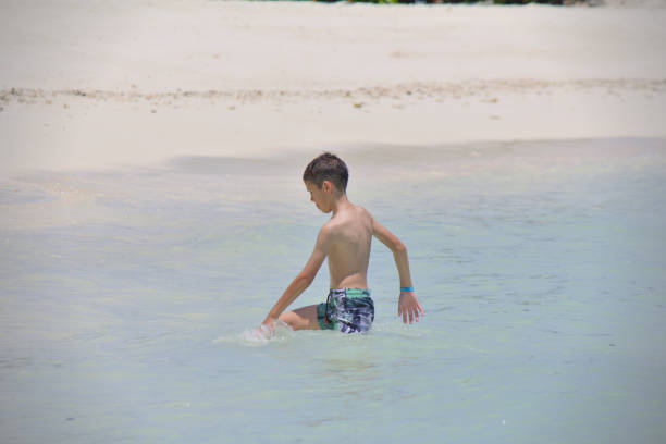 Underwater shot of small boy swimming in the backyard pool