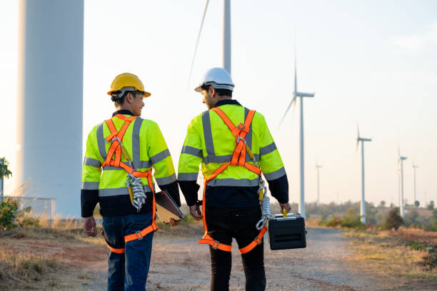 istock Diverse ethnicity male technicians working in the wind turbines field. Innovation engineer men wearing safety gear, work to develop environmental renewable clean energy outdoors at windmill power farm 2172768761