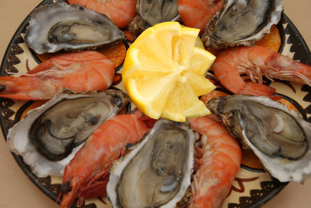 Opened oysters and large cooked shrimp  Meal served with lemon