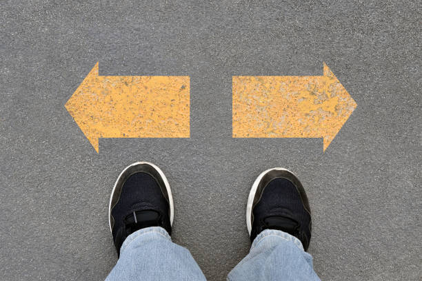 istock person standing behind right and left arrow direction to choose 2172772830