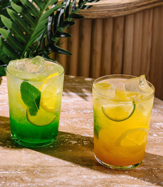 istock Two refreshing summer cocktails with lime and lemon standing on table 2172773223