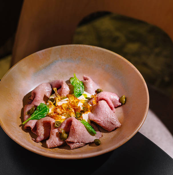 Delicious vitello tonnato dish served on elegant plate in restaurant setting