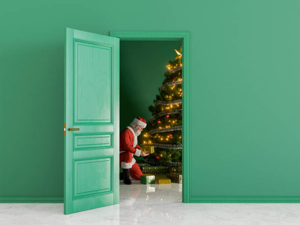 istock Santa Claus placing Christmas gifts under tree in empty room 2172776532