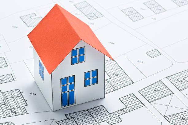 istock Cadastral map with buildings, building plot and free land parcel for house construction - building activity and permit concept with home model 2172785063