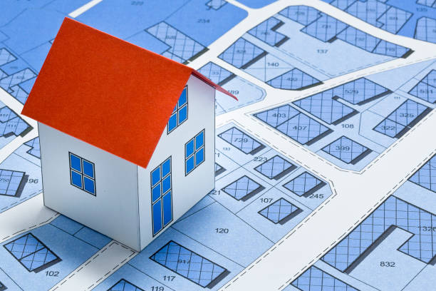 istock New home and free vacant land for building activity - Construction industry and building permit concept with a residential area, cadastral map, General Urban Planning and zoning regulations 2172785429