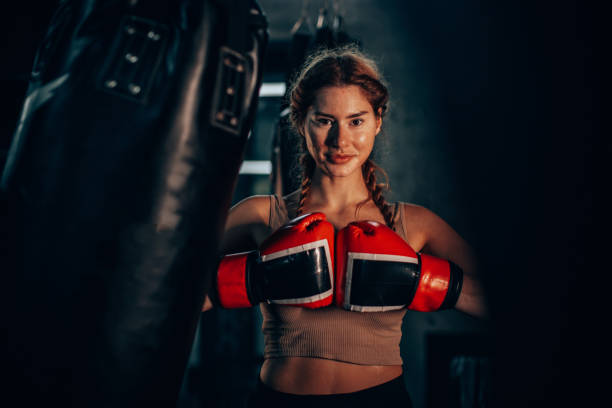 istock Determined female boxer training intensely in gym 2172785525