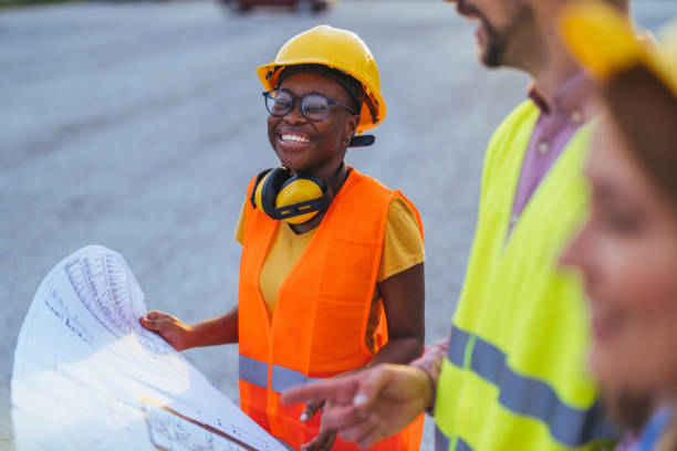 istock Smiling Female Engineer Discussing Construction Plans Outdoors 2172787404