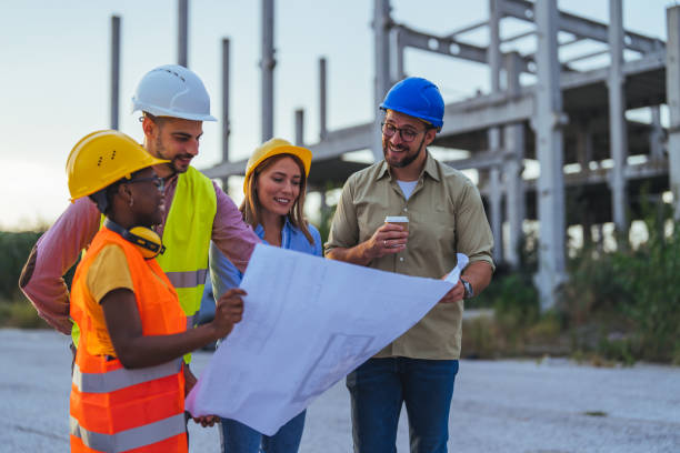 istock Construction Team Reviewing Blueprints at Building Site 2172787498