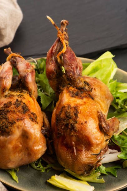 istock Baked tasty quails on ceramics plate with salad 2172789963