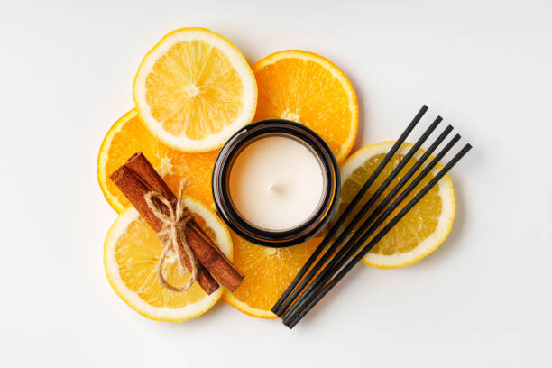 istock Aromatic arrangement featuring citrus slices and a scented candle on a white surface 2172793433