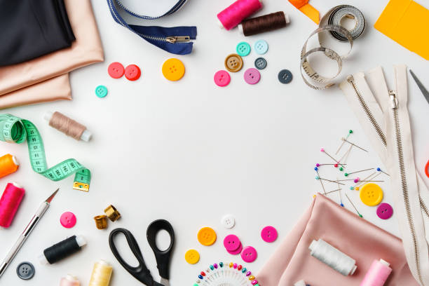 istock Crafting supplies arranged on a table with fabric, thread and buttons during daytime 2172793456