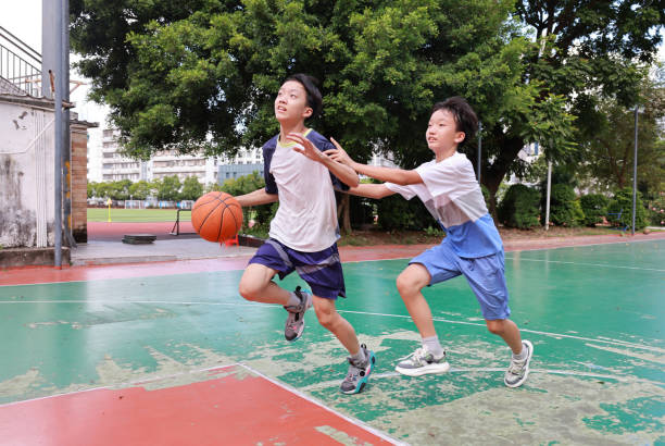 istock Two boys playing basketball 2172797779