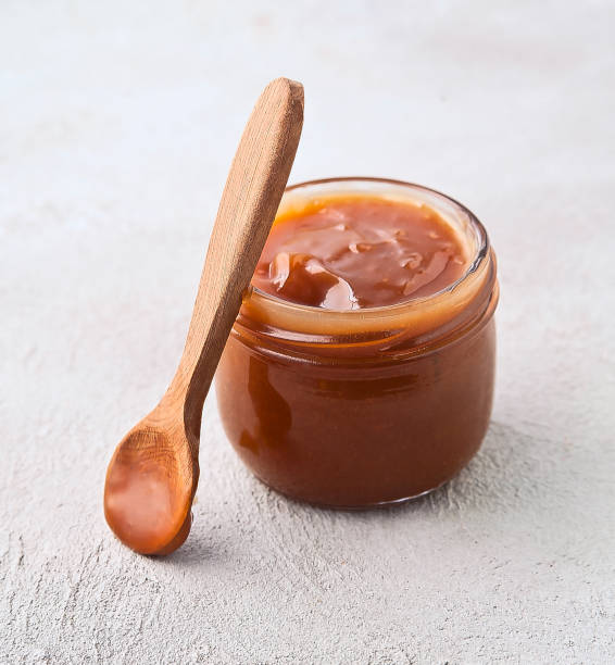 istock Liquid melted caramel sauce in jar 2172798615